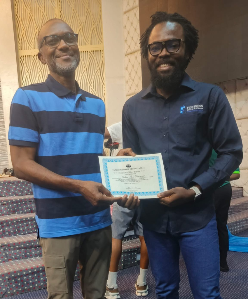 Nathan and Pastor with Baptismal certificate