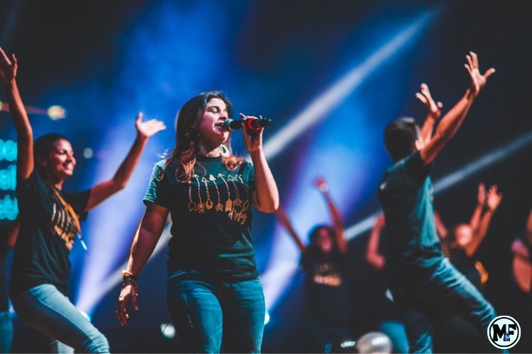 Mercy to Faith blog Images - A lady Leading Worship In Church